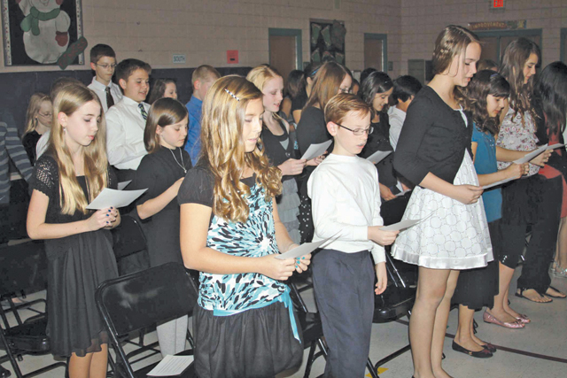 inductees take the pledge at Honor Society