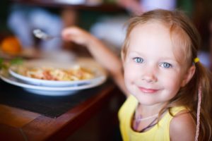 16404771 - portrait of adorable little girl having lunch