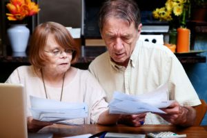 5690916 - senior couple at home organizing many bills