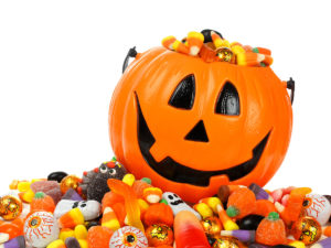 31906606 - halloween jack o lantern pail overflowing with candy