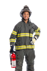 Firefighter in uniform holding fire extinguisher