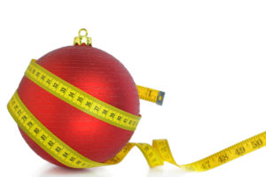 Christmas ball with measuring tape isolated on white