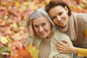 Mother and her nice daughter in autumn park