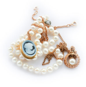 Vintage  gold jewelry pendant, brooch, cameo, pearl strand isolated
